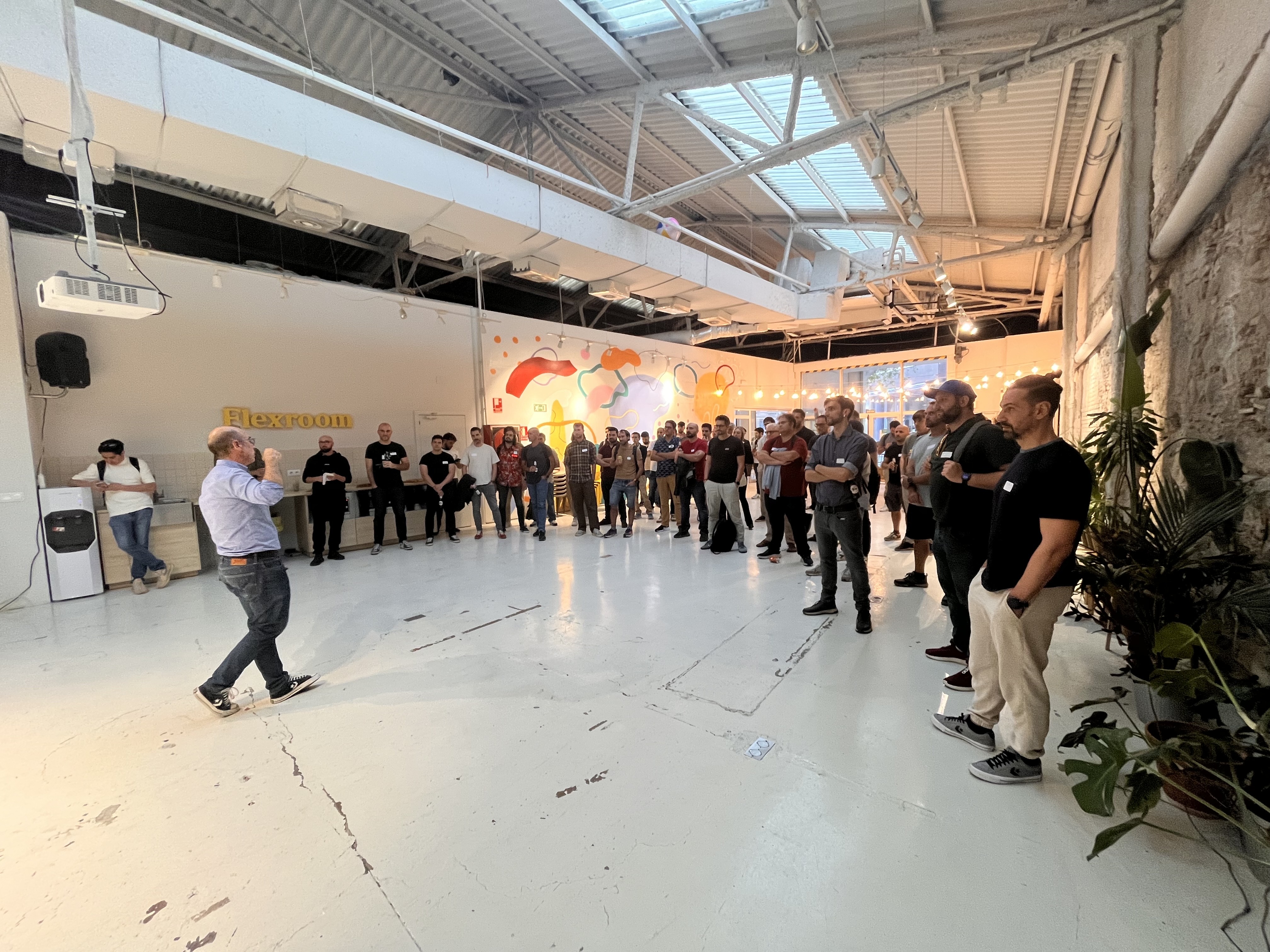 CTO Circle attendees gathered around a standing talk in a previous event space